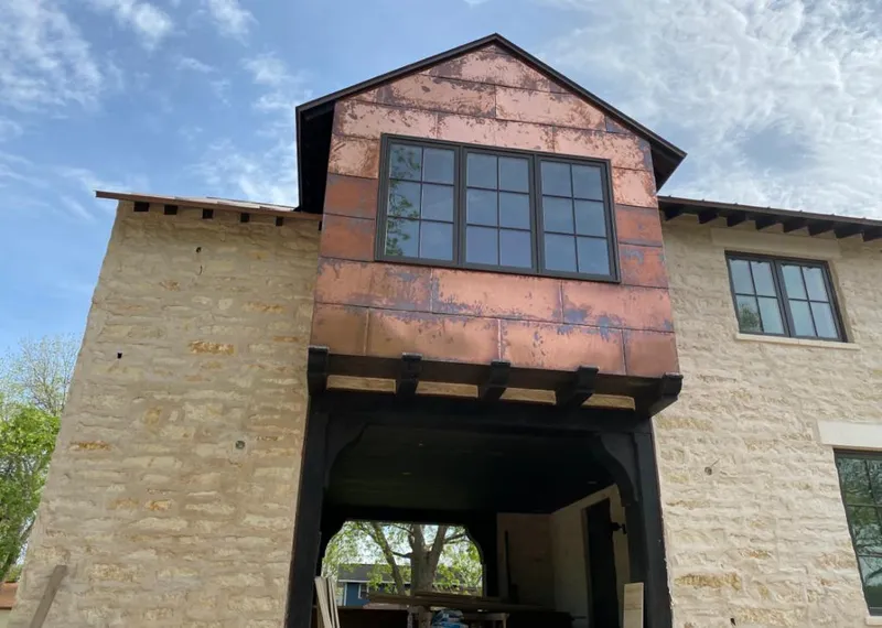Copper metal panel facade on a stone building for Metal Roof Coating in Rogers